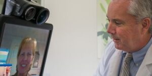male physician using telehealth on patient